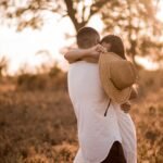 man in white shirt carrying woman in white dress during daytime